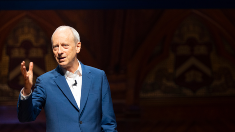 Michael Sandel addresses audience in Sanders Theater