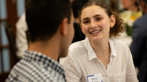 Maya Rosen talks to another Undergraduate Fellow at the E&L Safra Center Opening Dinner