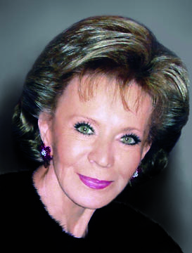 Smiling woman with short blonde hair and green eyes