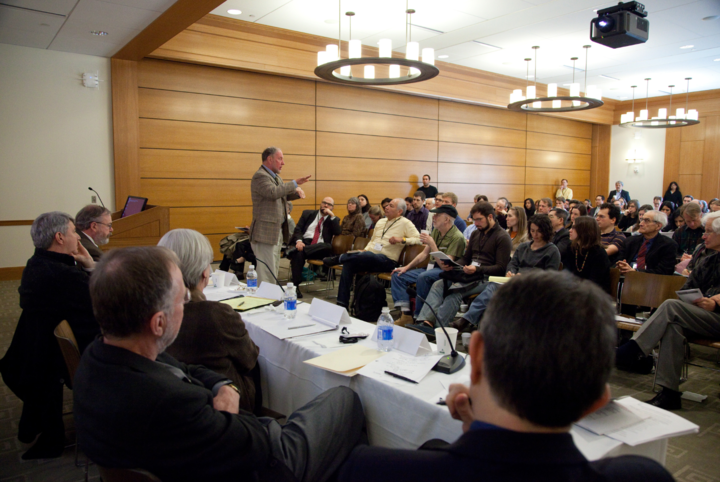 Man addresses a full lecture hall at the Institutional Corruption Conference