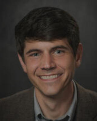 smiling man with short brown hair