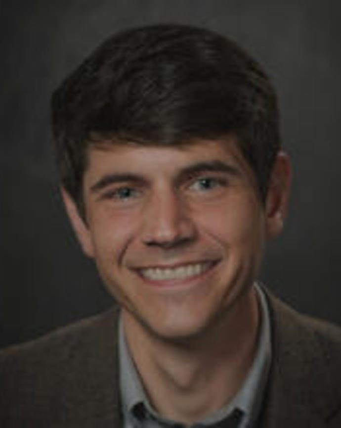 smiling man with short brown hair
